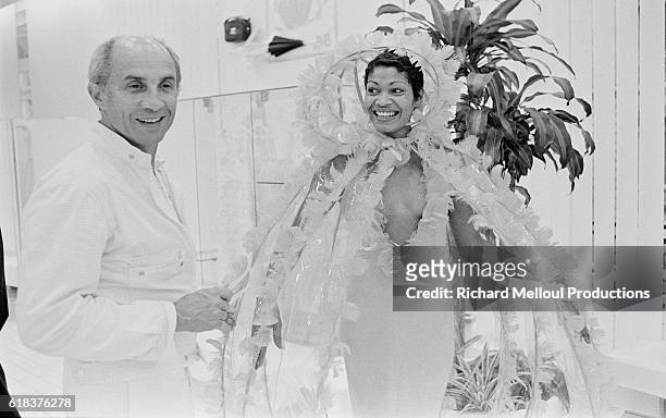 French fashion designer André Courrèges and one of his models share a laugh backstage at the Chanel 1975-1976 autumn-winter fashion show in Paris....