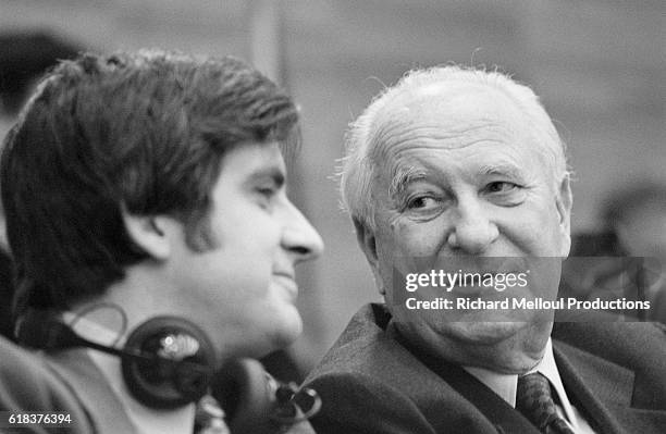 French Socialist politicians Jean-Pierre Chevenement and Gaston Deferre converse during a summit of southern European Socialists.