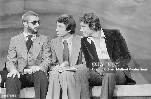 Beatles drummer Ringo Starr on a French television show with guest Sacha Distel and presenter Michel Drucker .