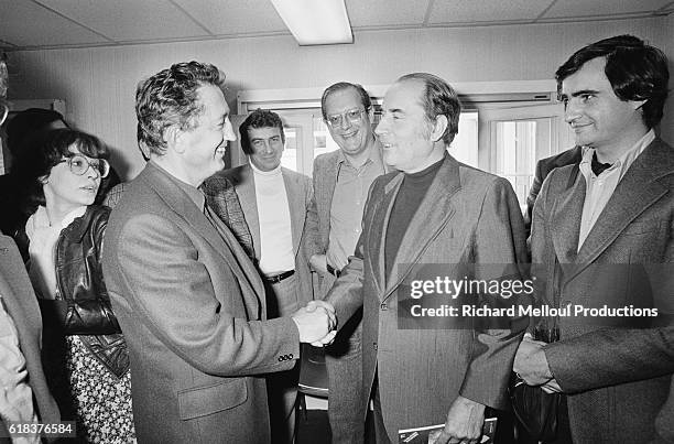 Secretary General Edmond Maire shakes hands with Socialist leader Francois Mitterrand during a meeting in Paris. Maire led the CFDT from 1971 to 1988.