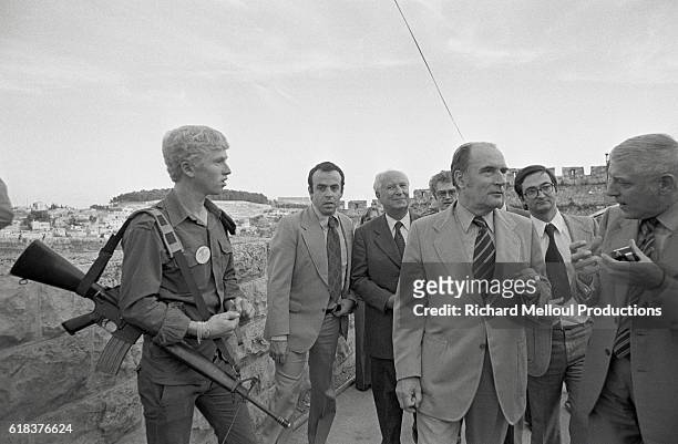 The French Socialist Party's first secretary Francois Mitterand talks with French politicians Gaston Deferre and Jacques Attali at the Western Wall...