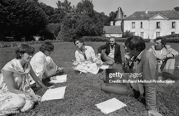 Jean-Claude Brialy and a group of actors rehearse for a new play at his castle in Monthion, France. The production, Si t'es Beau t'es Con, will be...
