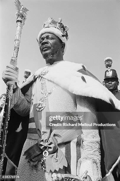 Jean-Bedel Bokassa wears a royal crown and cape and holds a scepter on the day he is crowned Bokassa I, Emperor of the Central African Empire....