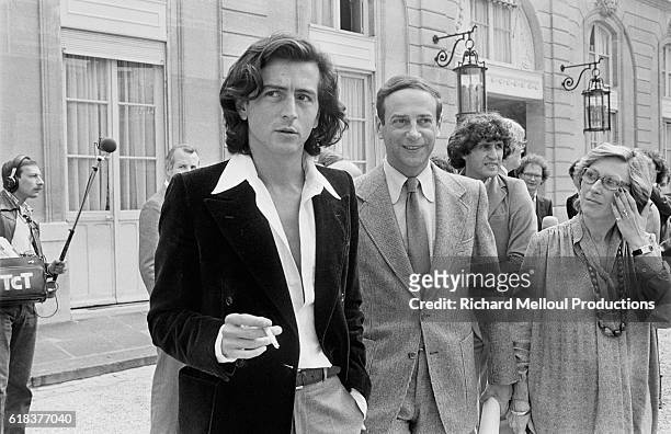 Bernard-Henri Levy and Lionel Stoleru talk in the Palais de l'Elysee courtyard after attending lunch with French President Valery Giscard d'Estaing....