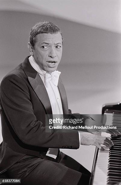 French pianist and singer Henri Salvador tapes a 1978 Christmas program. The show is being directed by Roger Pradines, and will feature as guests...