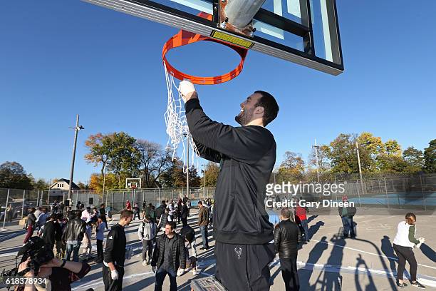 Miles Plumlee of the Milwaukee Bucks joins up with community groups and Precision Sports to refurbish outdoor public basketball courts at Mitchell...