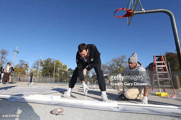 Miles Plumlee of the Milwaukee Bucks joins up with community groups and Precision Sports to refurbish outdoor public basketball courts at Mitchell...