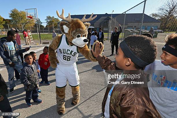 Bango, macot of the Milwaukee Bucks, joins up with community groups and Precision Sports to refurbish outdoor public basketball courts at Mitchell...