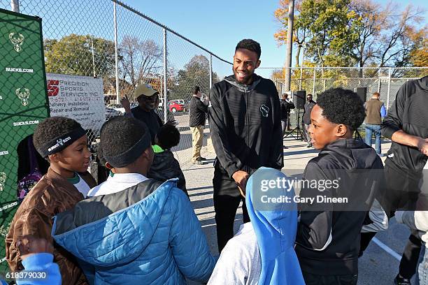 Jabari Parker of the Milwaukee Bucks joins up with community groups and Precision Sports to refurbish outdoor public basketball courts at Mitchell...