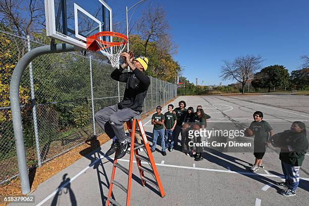 Michael Beasley of the Milwaukee Bucks joins up with community groups and Precision Sports to refurbish outdoor public basketball courts at Mitchell...