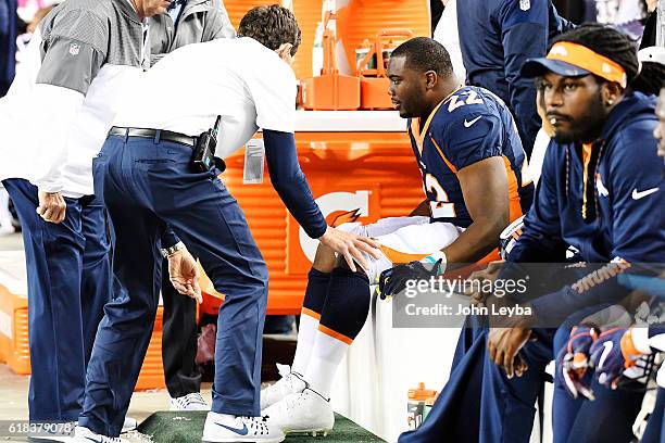 Anderson of the Denver Broncos is sits on the bench as medical staff tends to him after he was tackled by A.J. Bouye of the Houston Texans and Andre...