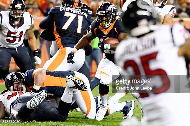 Anderson of the Denver Broncos runs for a touchdown as Matt Paradis drives Brandon Dunn of the Houston Texans to the grass during the second quarter...