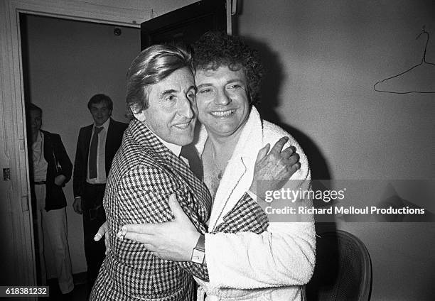 French actor Jacques Martin hugs actor Jean Lefebvre backstage at the Theatre de la Michodiere after performing his play "Une Case de Vide". Martin...