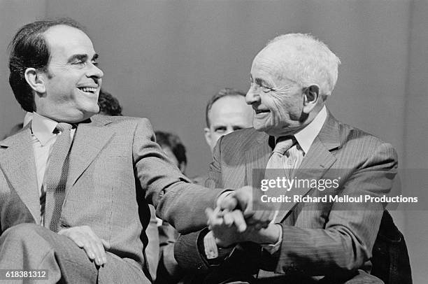 French politician and Secretary General of the Parti Communiste Francais Georges Marchais greets French writer Louis Aragon at a PCF meeting at the...