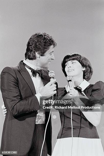 French singers Sacha Distel and Mireille Mathieu performing on the television program Numero 1. Distel is an acclaimed jazz guitarist and Mathieu was...