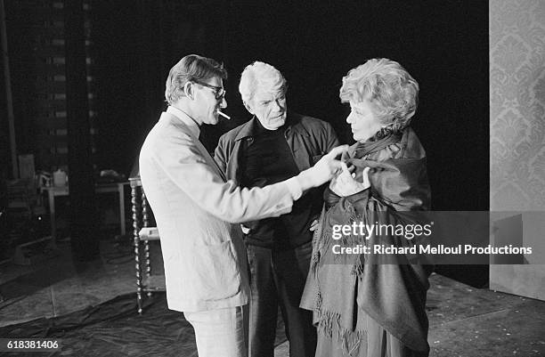 Actor Jean Marais watches as fashion designer Yves Saint Laurent fits a costume to Edwige Feuillere for an upcoming production of Dear Liar. The...