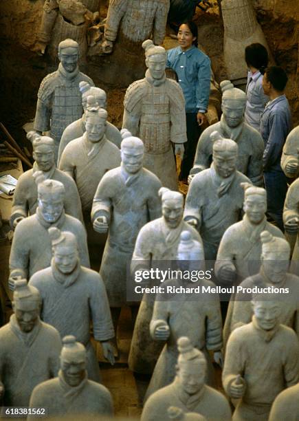 Archaeologists stand among the terracotta warriors at the Mausoleum of the First Qin Emperor in Lintong District, Xi'an, Shaanxi province, China.