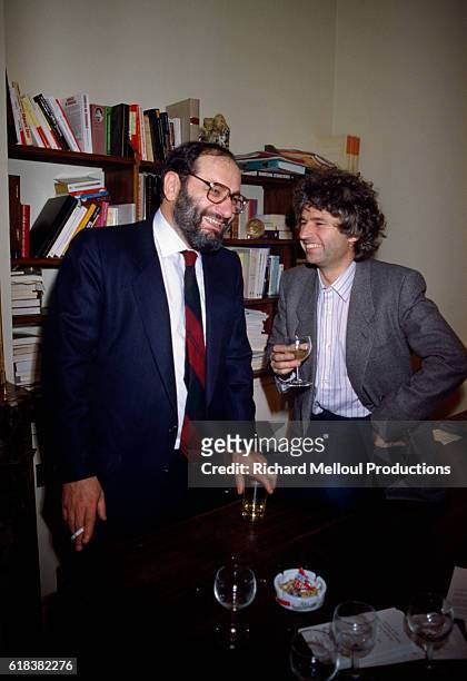 Italian writer Umberto Eco and French filmmaker Jean-Jacques Annaud share a laugh in a Paris office. Annaud would later direct a film adaptation of...