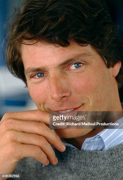 American actor Christopher Reeve smiles as he puts his hand to his chin. Reeve was in Cannes to attend the 37th Cannes Film Festival.