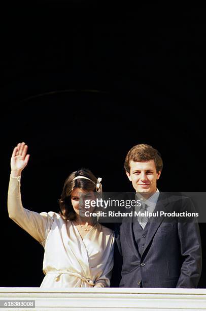 Princess Caroline of Monaco waves to admirers as she stands on a balcony with her new husband Stefano Casiraghi at the Royal couple's wedding.