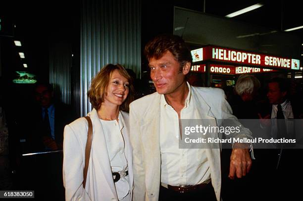 French actress Nathalie Baye and French singer Johnny Hallyday arrive at the airport in Cannes. The couple is in Cannes for the 1984 Cannes Film...