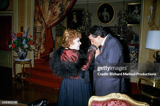 French comedian Jackie Sardou and her son, the popular singer Michel Sardou on the set of Sacha Guitry's play N'Ecoutez Pas Mesdames . In a gesture...