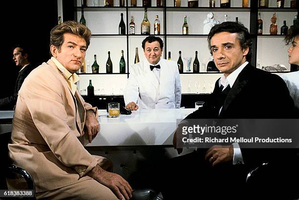 French singers Eddy Mitchell and Michel Sardou join comedian Coluche on the set of the television program Show Sardou.