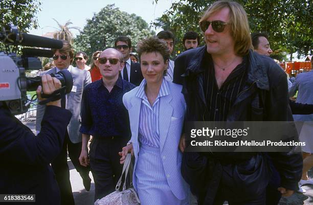 Actors Michel Blanc, Miou-Miou, and Gerard Depardieu, stars of the film Tenue de Soiree , arriving at the Cannes Film Festival.