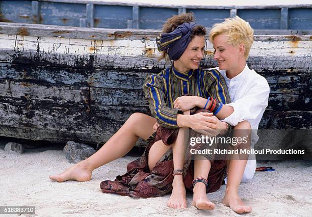 French actress Miou-Miou and her sister Marie-Claude share an embrace on the beach in Mauritius, France.