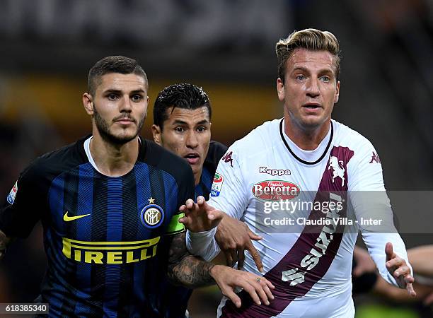 Mauro Icardi of FC Internazionale and Maxi Lopez of FC Torino compete during the Serie A match between FC Internazionale and FC Torino at Stadio...