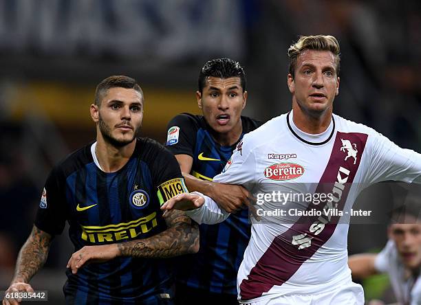 Mauro Icardi of FC Internazionale and Maxi Lopez of FC Torino compete during the Serie A match between FC Internazionale and FC Torino at Stadio...
