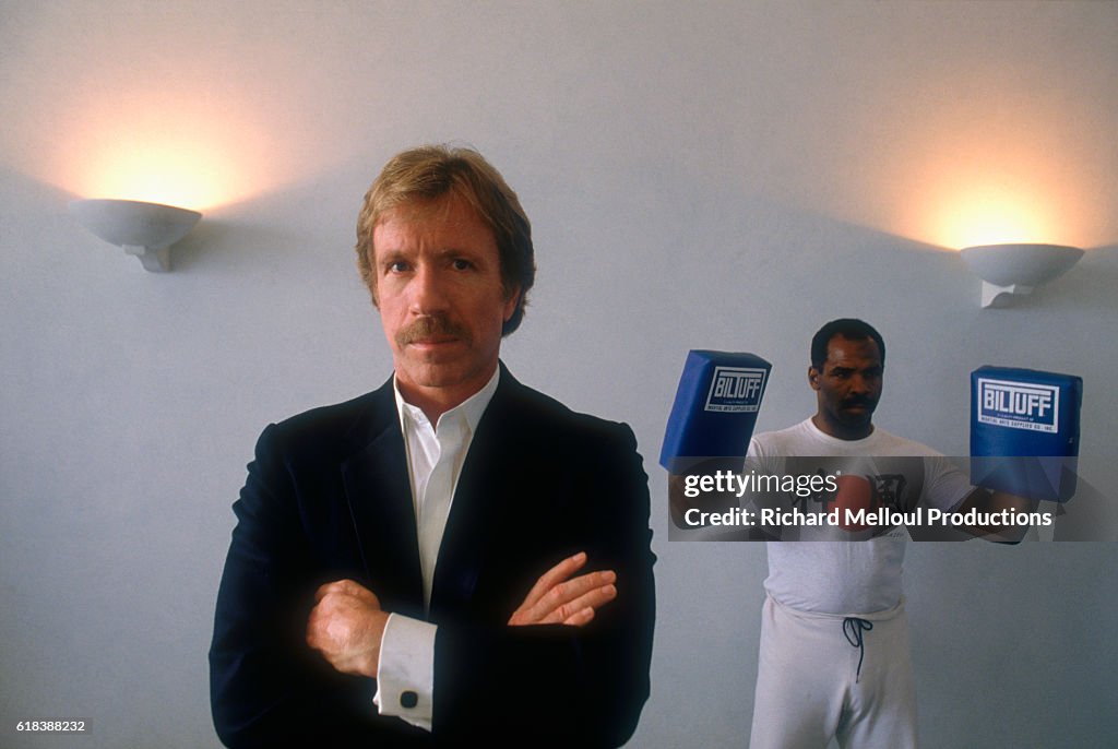 Actor Chuck Norris Standing near Trainer