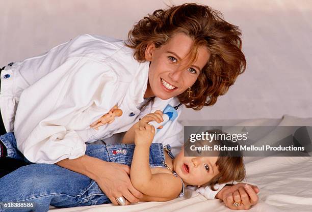 French actress Fiona Gelin lies with her young son, Milan.