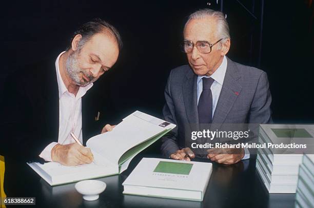 Art collector Leo Castelli and French film director Claude Berri sign copies of the art book that they wrote together entitled Claude Berri Meets Leo...