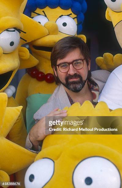 Cartoonist Matt Groening poses with chaaracters from his animated TV series 'The Simpsons', November 1990.