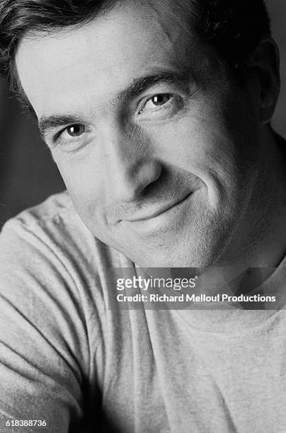 French actor Francois Cluzet smiles in Paris.