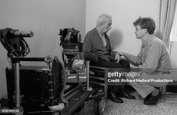 Co-directors Michelangelo Antonioni and Wim Wenders talking on the set of the Franco-Italian-German film Al di la delle Nuvole . The film, based on a...