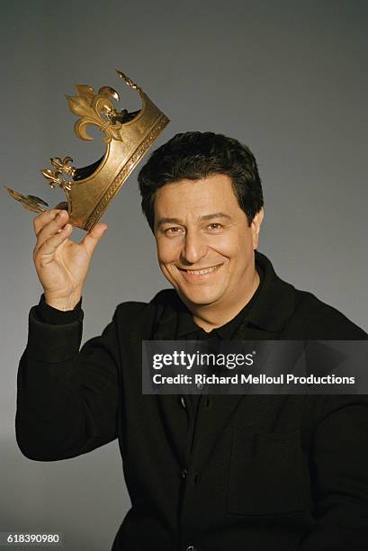 Actor Christian Clavier holds a crown used in his 1998 French film Couloirs du Temps: Les Visiteurs 2. The movie, directed by Jean-Marie Poire and...