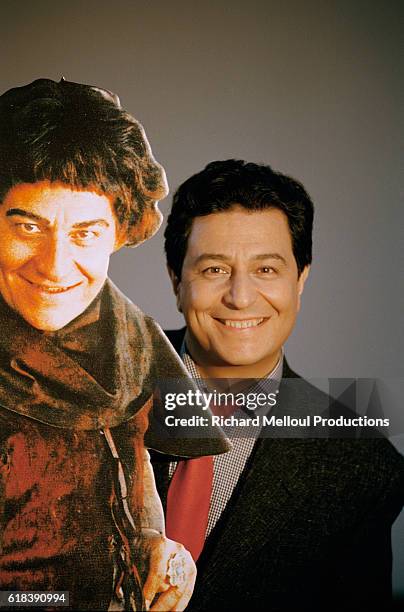 Actor Christian Clavier stands with a cardboard figure of himself from the 1998 French film Couloirs du Temps: Les Visiteurs 2. The film, directed by...