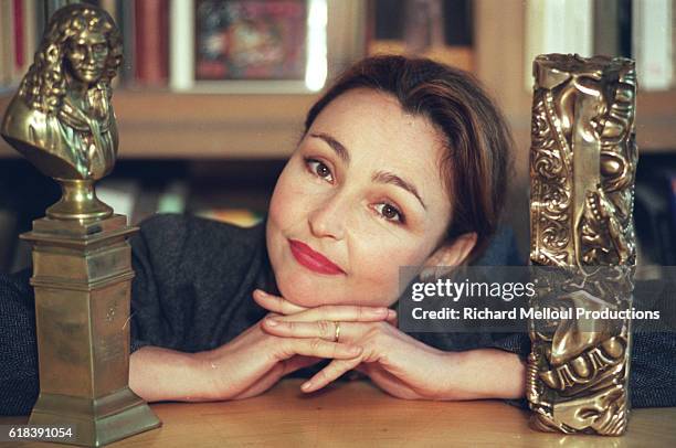 French actress Catherine Frot poses at home in Paris with her Cesar and Moliere awards.
