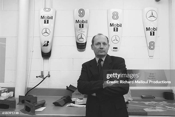 British racecar manager Ron Dennis stands in front of hoods at the McLaren Formula 1 workshops in Woking.