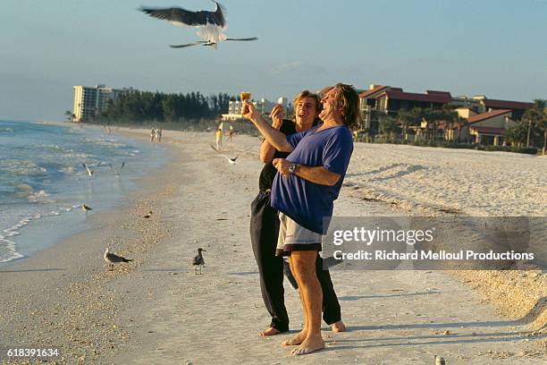 Gerard and his son Guillaume Depardieu walk along the beach during the Sarasota French Film Festival.