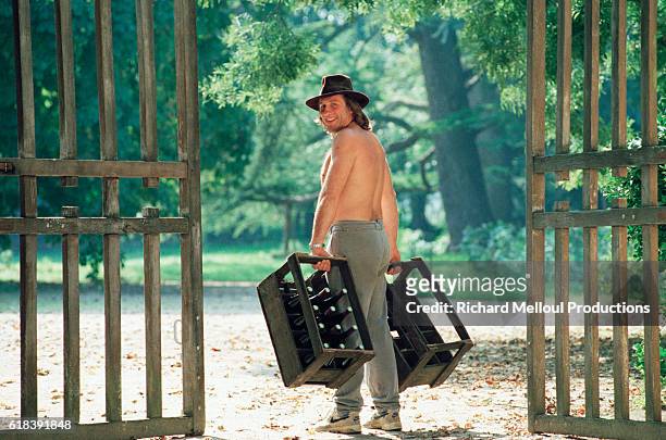 French actor Gerard Depardieu working in his vineyard. | Location: Tigne, France.