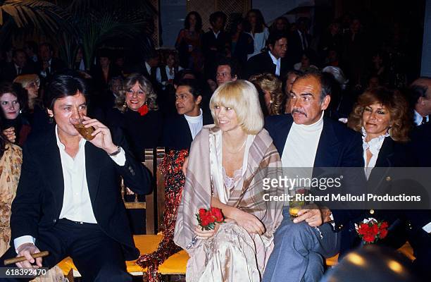 From left, French actor Alain Delon , actress Mireille Darc, and Scottish actor Sean Connery enjoying the entertainment at the inauguration of...