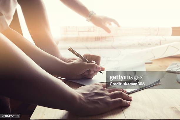 close-up hand of male architect drawing blueprint on work space - writing instrument stock pictures, royalty-free photos & images