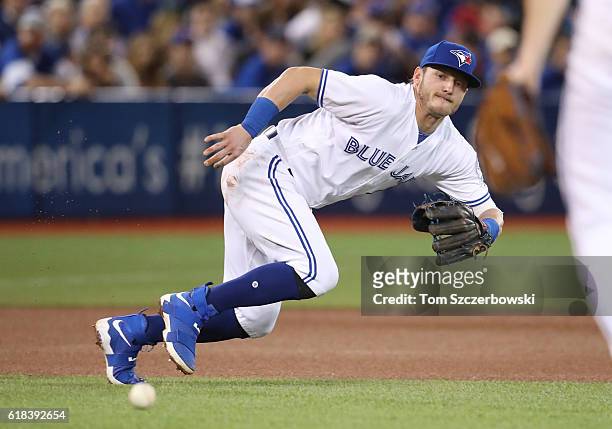 Josh Donaldson of the Toronto Blue Jays goes after but cannot get to a single through the hole hit by Michael Bourn of the Baltimore Orioles in the...