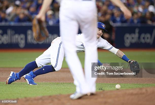 Josh Donaldson of the Toronto Blue Jays dives but cannot get to a single through the hole hit by Michael Bourn of the Baltimore Orioles in the fourth...