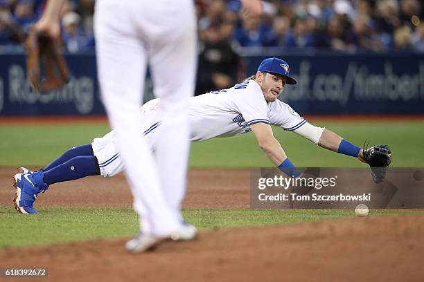 Josh Donaldson of the Toronto Blue Jays dives but cannot get to a single through the hole hit by Michael Bourn of the Baltimore Orioles in the fourth...