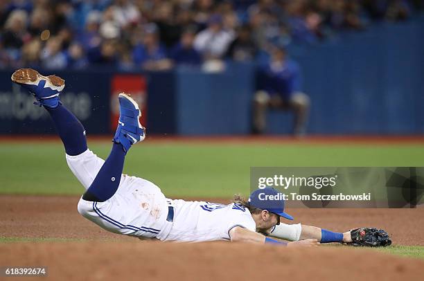 Josh Donaldson of the Toronto Blue Jays dives but cannot get to a single through the hole hit by Michael Bourn of the Baltimore Orioles in the fourth...
