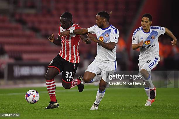 Olufela Olomola of Southampton and Jermain Defoe of Sunderland battle for possession during the EFL Cup fourth round match between Southampton and...